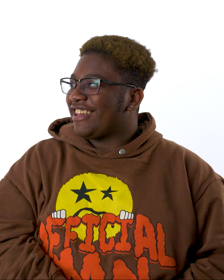 A young man with glasses smiling