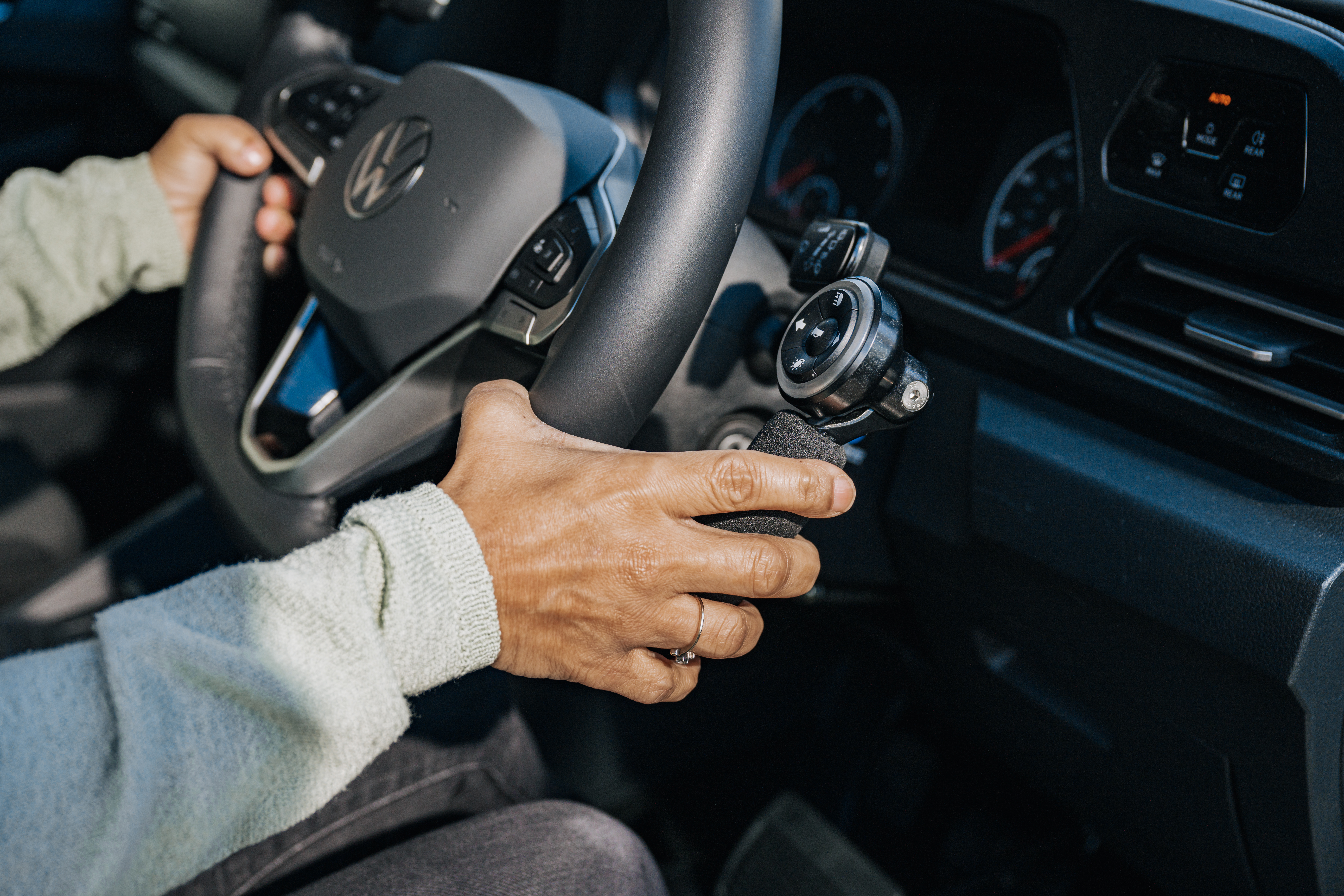 Close-up of a woman's hand using a steering wheel adaptation