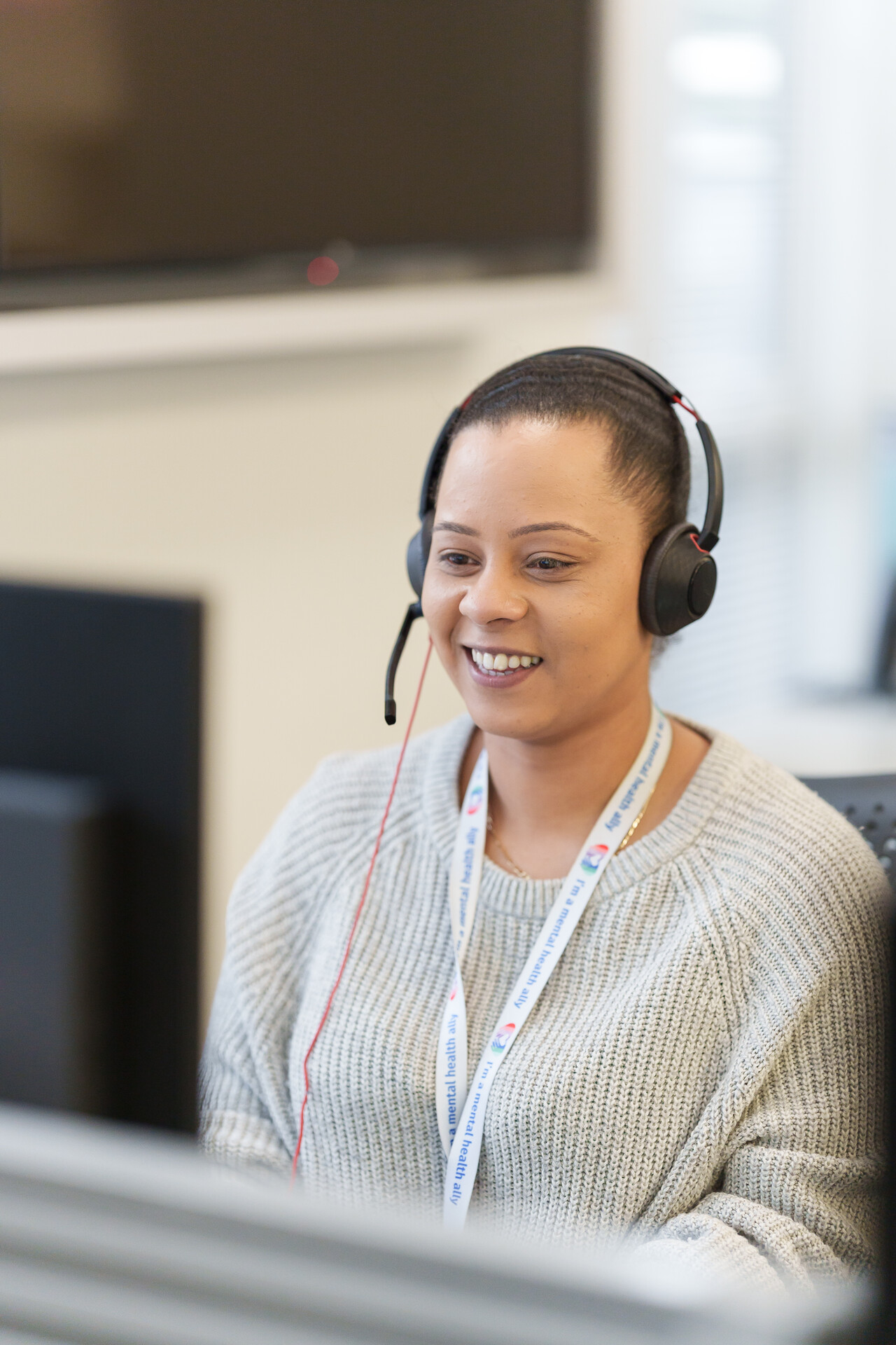 A woman with a headset in an office